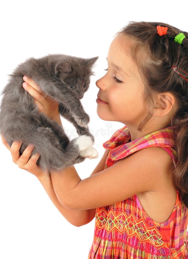 Little girl with gray kitty in hands