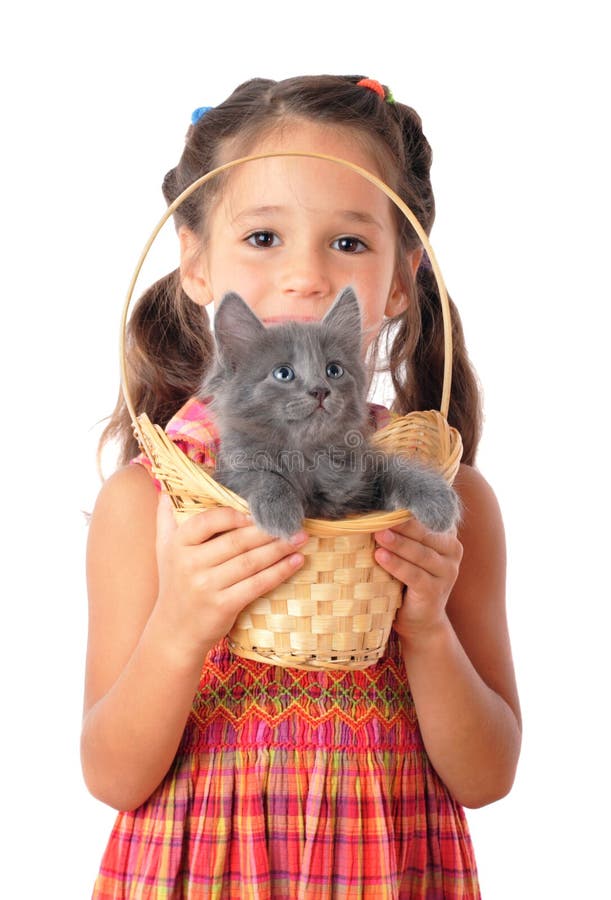 Little girl with gray kitty in wicker