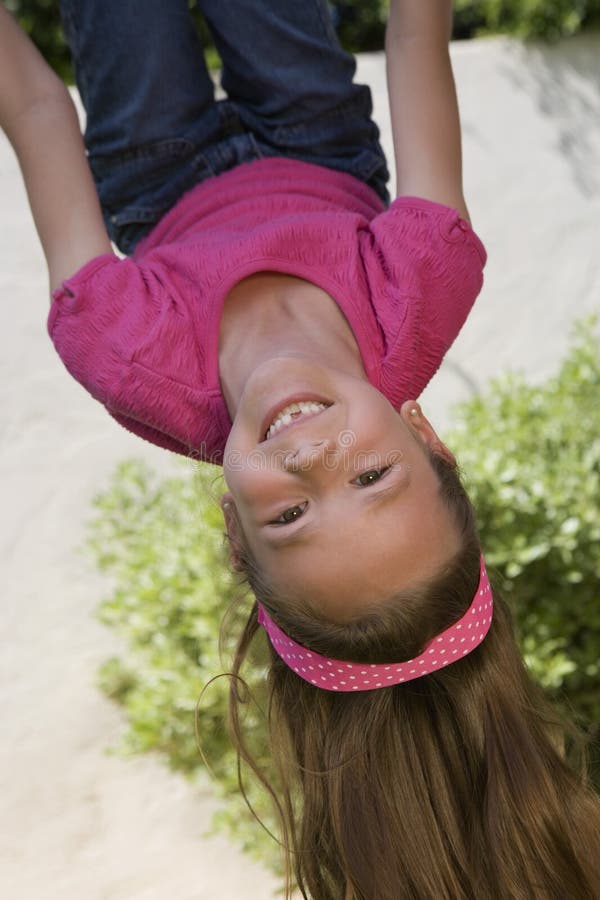 Little Girl Hanging Upside Down stock photo Little Girl Hanging Upside Down stock photo