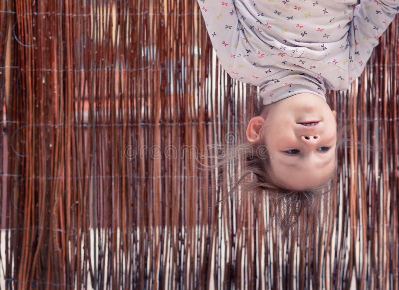 Little girl hanging upside down royalty free stock photo Little girl hanging upside down royalty free stock photo