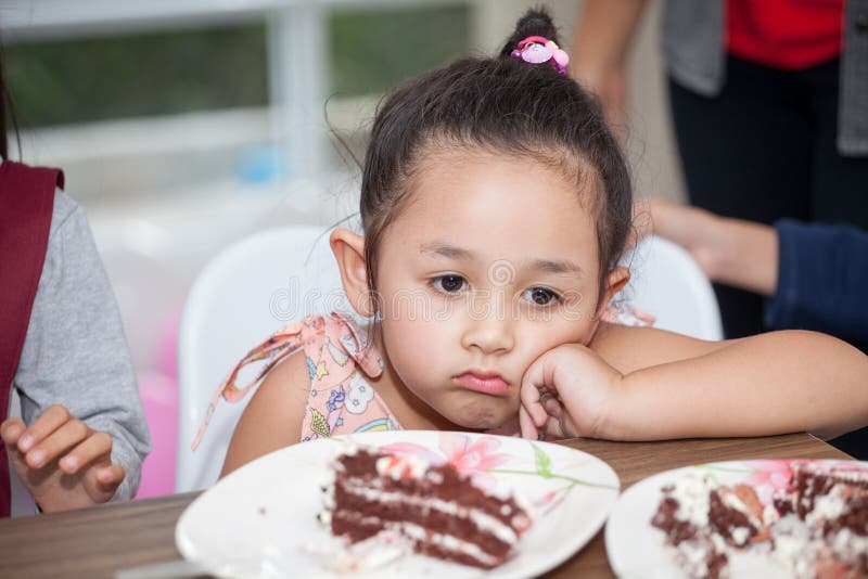 Little girl with hat bored eating birthday cake royalty free stock photo Little girl with hat bored eating birthday cake royalty free stock photo