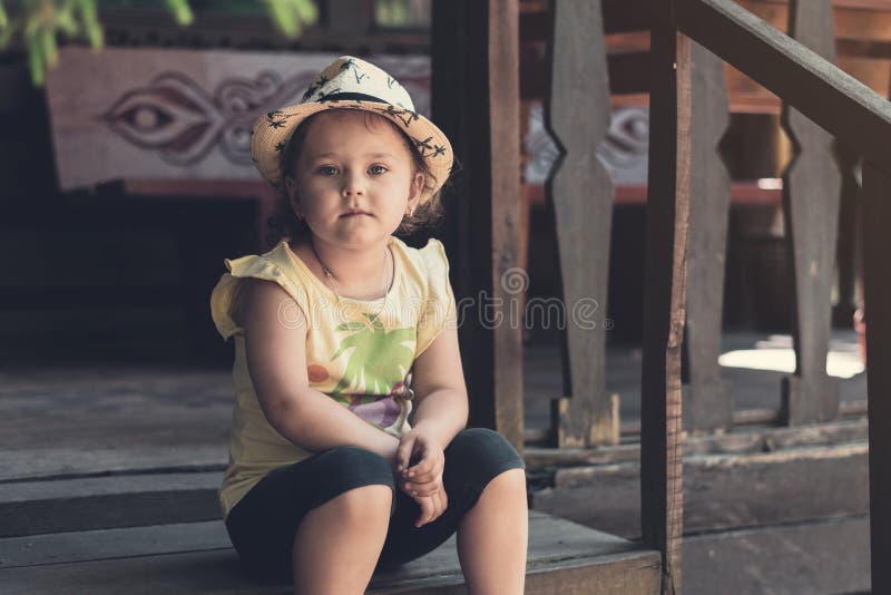 Beautiful Little Girl Sitting On Front Porch Stock Photo - Download Image Now - iStock