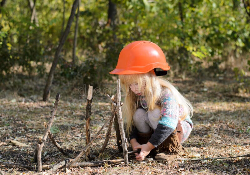 Little Girl with Helmet Playing with Sticks Stock Image - Image of ...