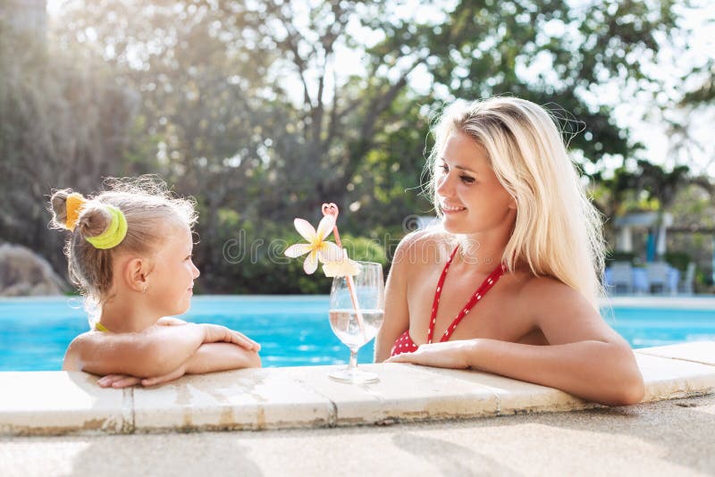 Little girl and her mother with cocktail in tropical beach pool royalty free stock image Little girl and her mother with cocktail in tropical beach pool royalty free stock image