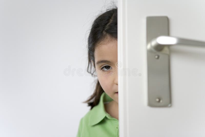 Little Girl Is Hiding Behind The Door Stock Image Image of expression