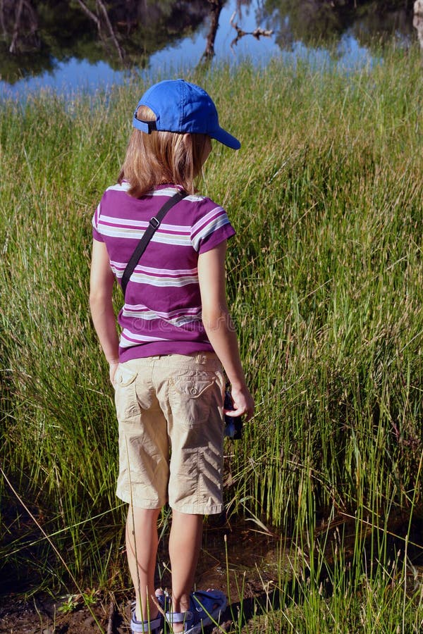 A Girl in Hiking Clothes Photographs Landscapes in the Mountains