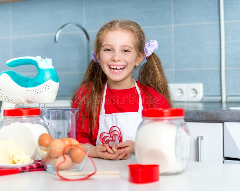 Little girl holding a cookie cutter