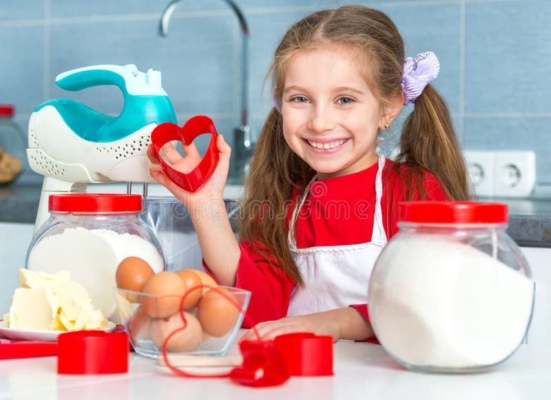 Little girl holding a cookie cutter