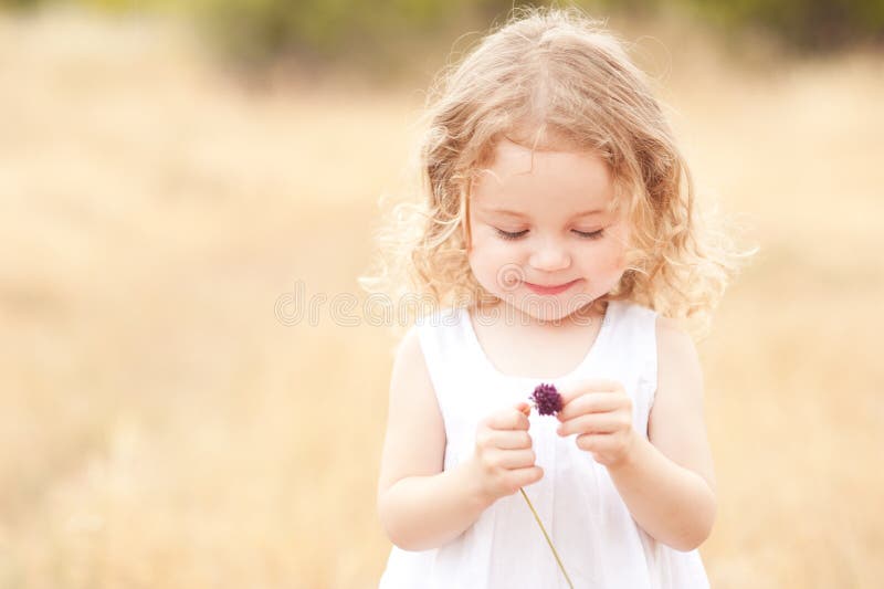 Little girl holding flower