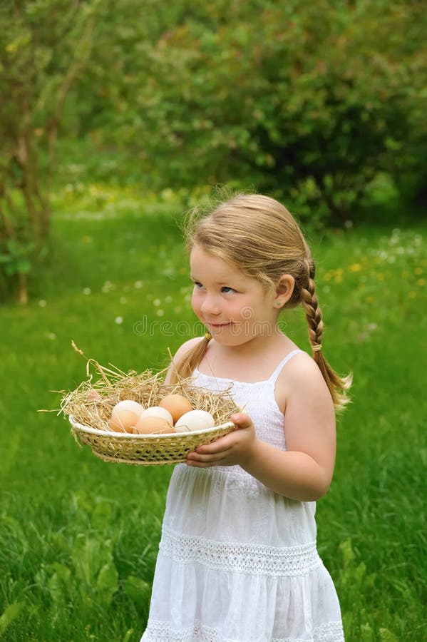 Little girl holding fresh eggs