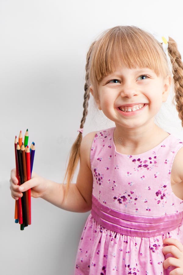 Little girl holding a pencil