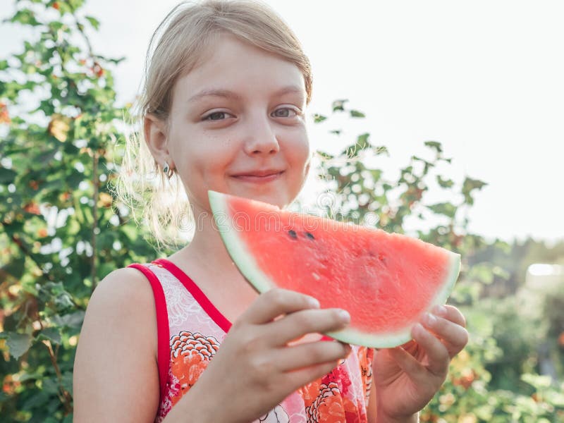 Little girl holding a slice of ripe red watermelon royalty free stock photos Little girl holding a slice of ripe red watermelon royalty free stock photos