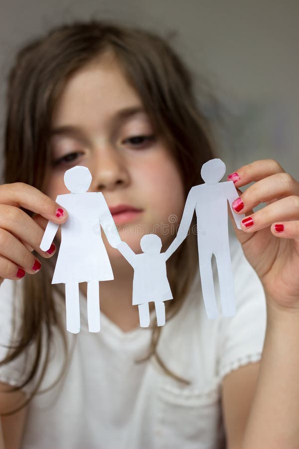 Little girl holds paper chain family; broken family or divorce c