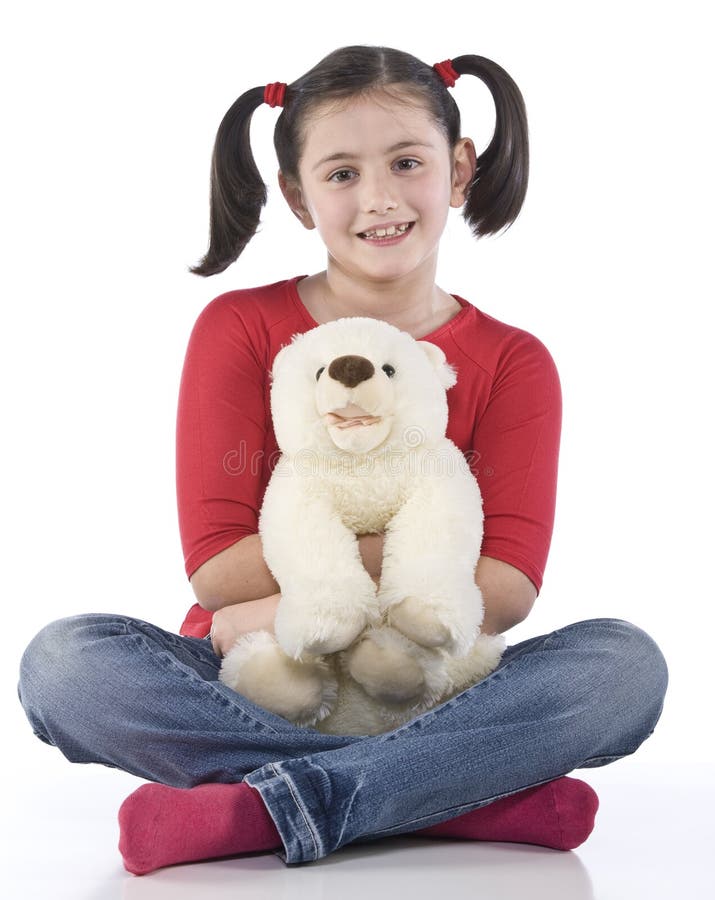 Little girl is hugging big teddy bear