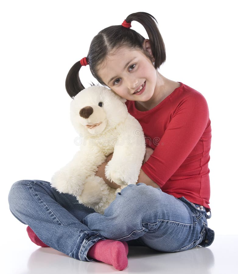 Little girl is hugging big teddy bear