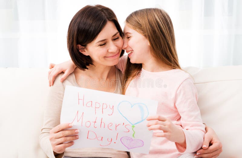 Little girl hugging her mother and holding greating card royalty free stock images Little girl hugging her mother and holding greating card royalty free stock images