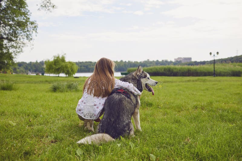 Teen Girl Hugs Her Husky Dog on a Day Off in a Meadow in Nature. Stock  Photo - Image of field, little: 186722832