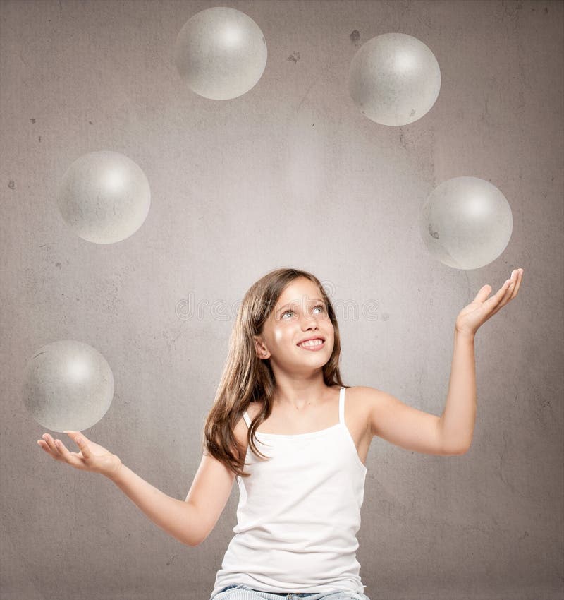 Little girl juggling with crystal sphere balls