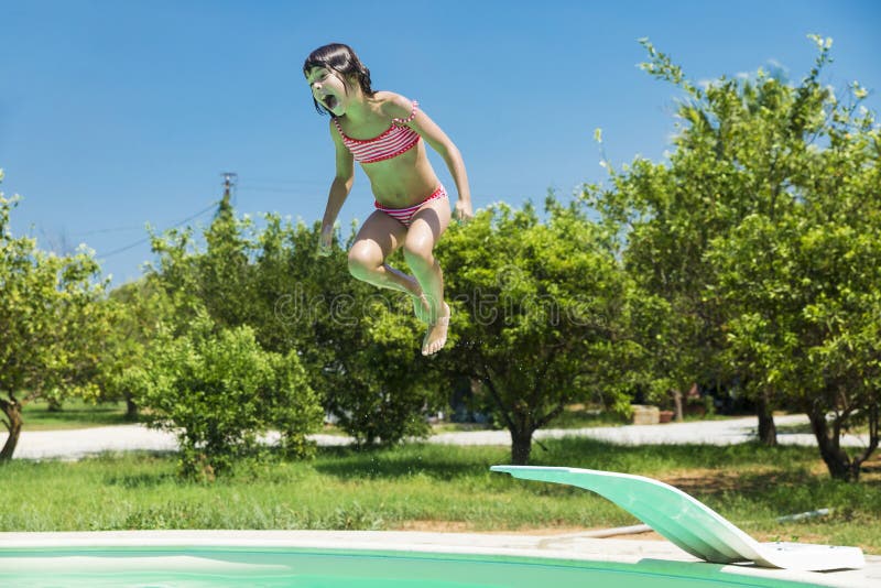 Little girl jumping in pump in an outdoor pool royalty free stock photos Little girl jumping in pump in an outdoor pool royalty free stock photos