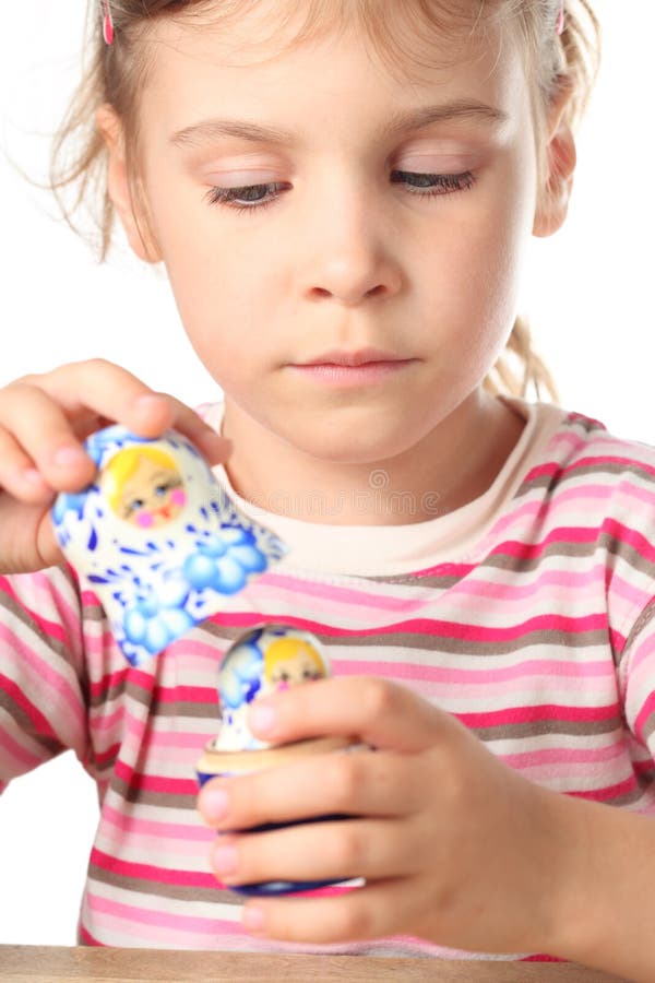 Little girl keep matryoshka isolated