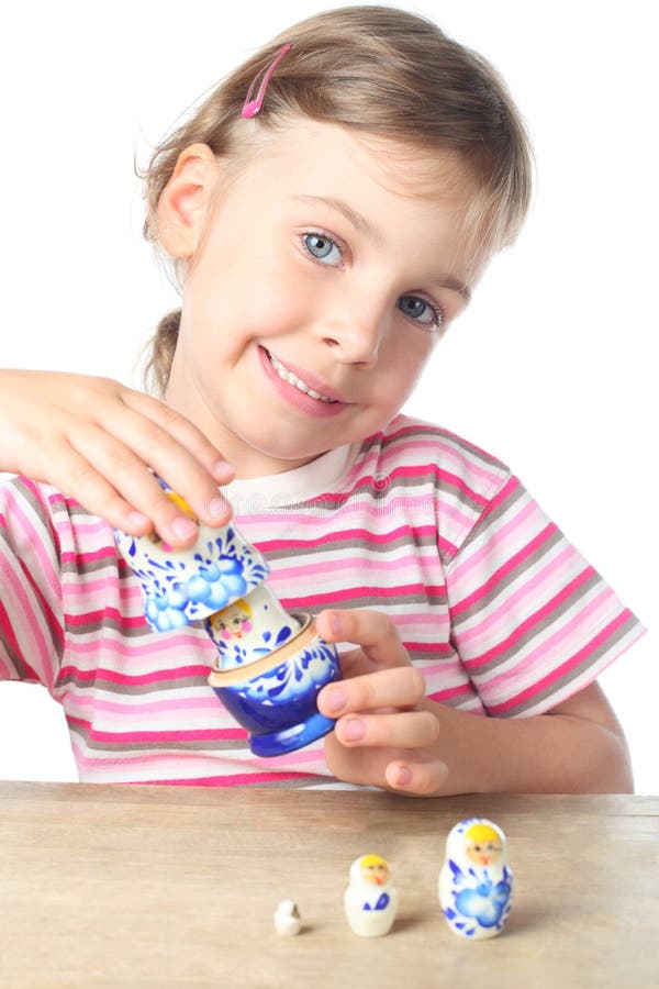 Little girl keep matryoshka and smiling isolated