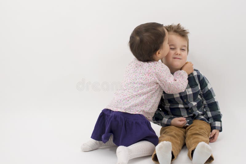 She and her older brother. Мальчик целует мальчика. Девочка целует брата. Сестра целует брата в щеку. Две девочки целуют мальчика в щеки.