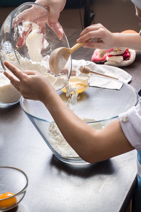Little girl kneading dough for cookies. Holiday Foods stock image Little girl kneading dough for cookies. Holiday Foods stock image