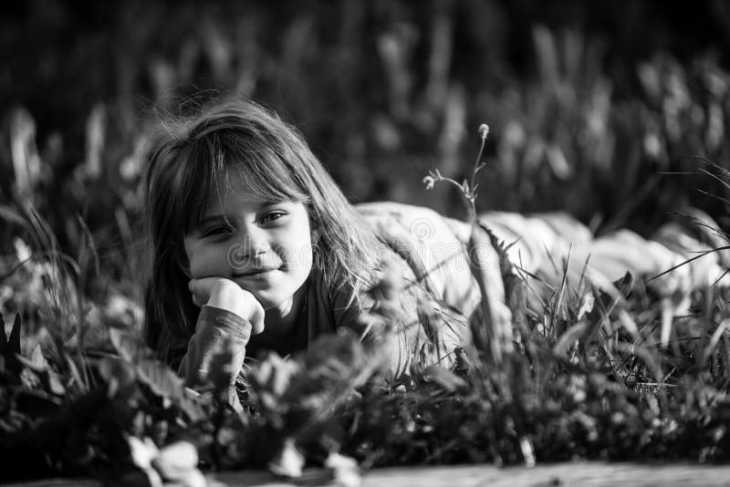 Little Girl Laying in Grass in the Park. Black and White Photo. Stock ...