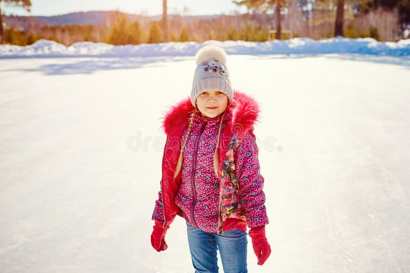The little girl learns to skate on a skating rink stock images The little girl learns to skate on a skating rink stock images