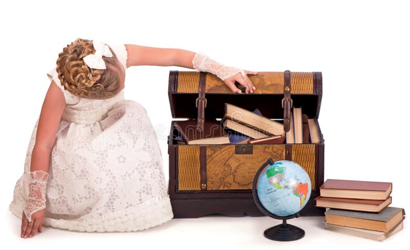 girl and a chest with books. little girl looking inside a trunk with surprise on white background