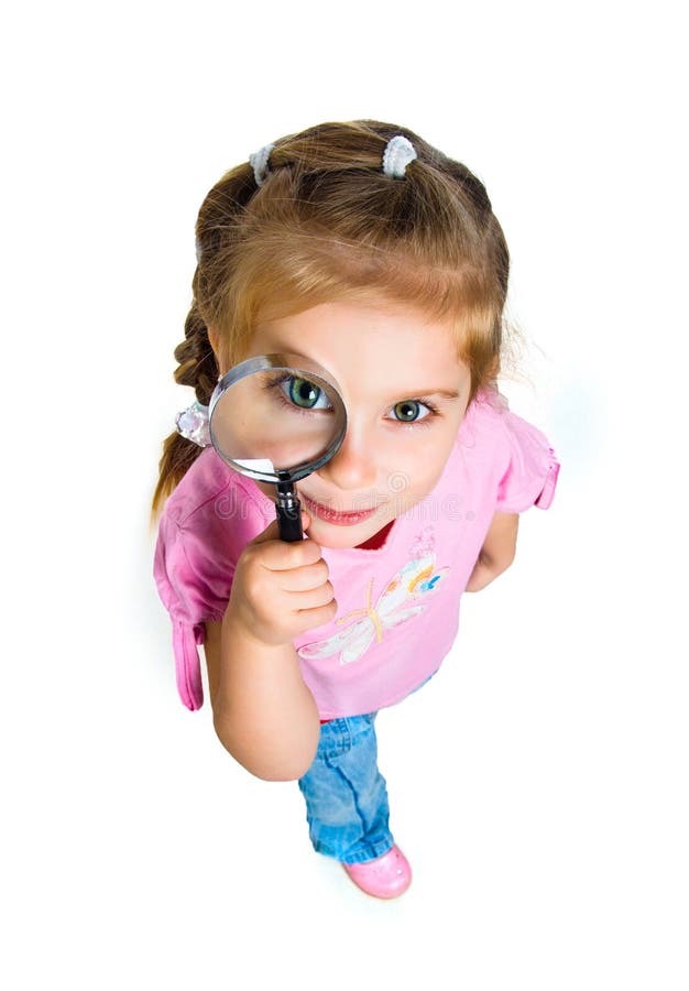 Little girl looking through a magnifier