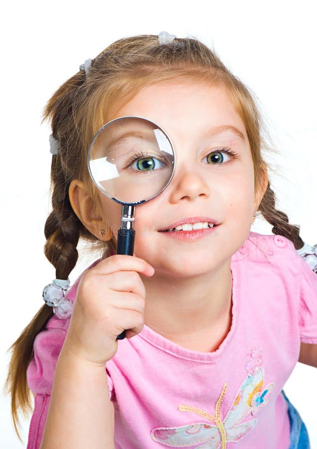 Little girl looking through a magnifier