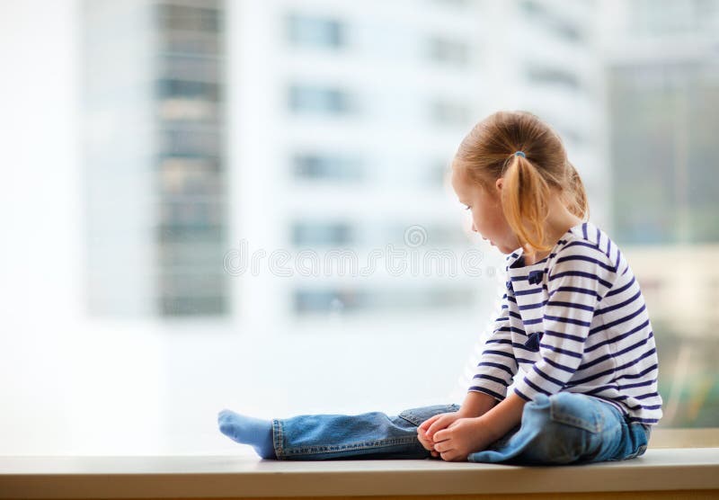 Little girl looking at window