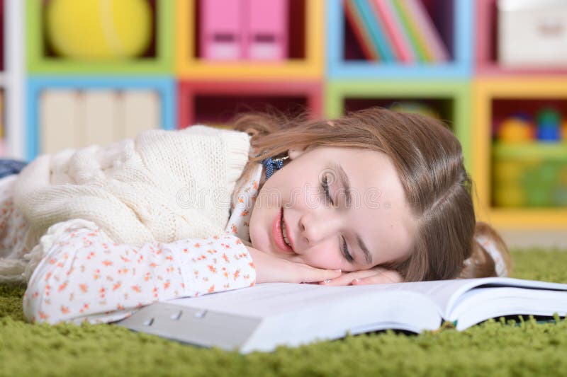 Little girl lying on green carpet