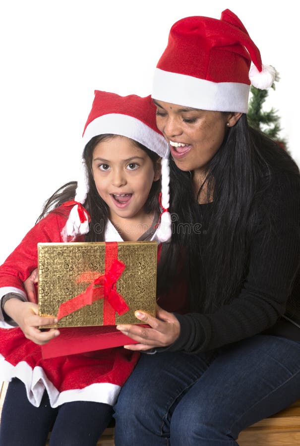 Little girl and Mother kissing and giving Xmas Present