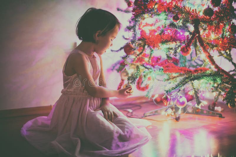Little girl near the Christmas tree stock photo Little girl near the Christmas tree stock photo