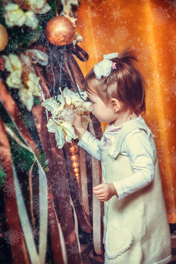 Little girl near the new year tree stock image Little girl near the new year tree stock image