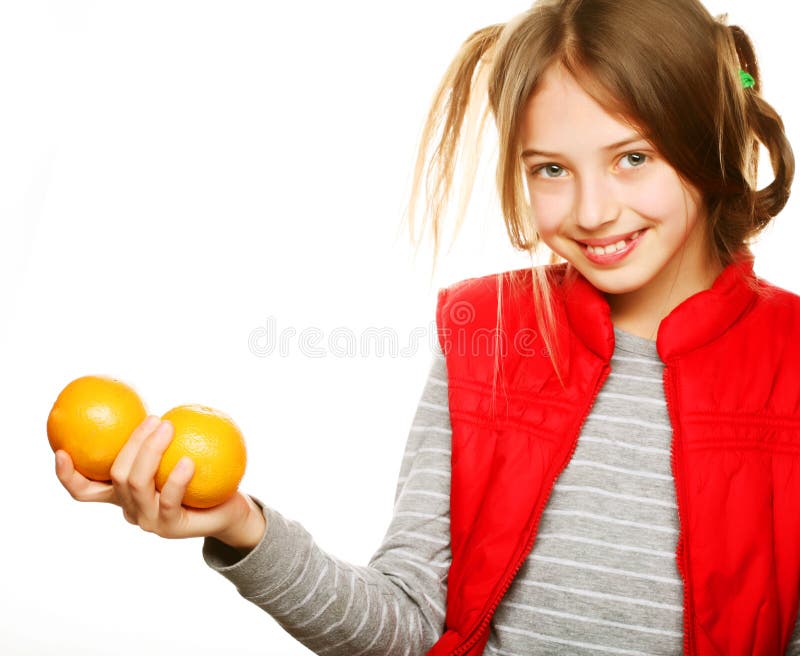 Little girl with oranges and juice