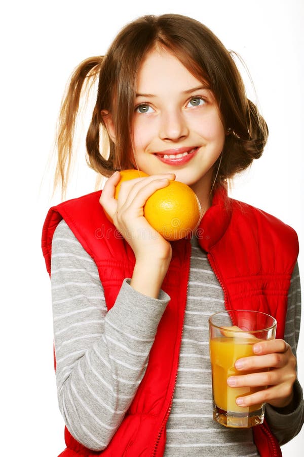 Little girl with oranges and juice