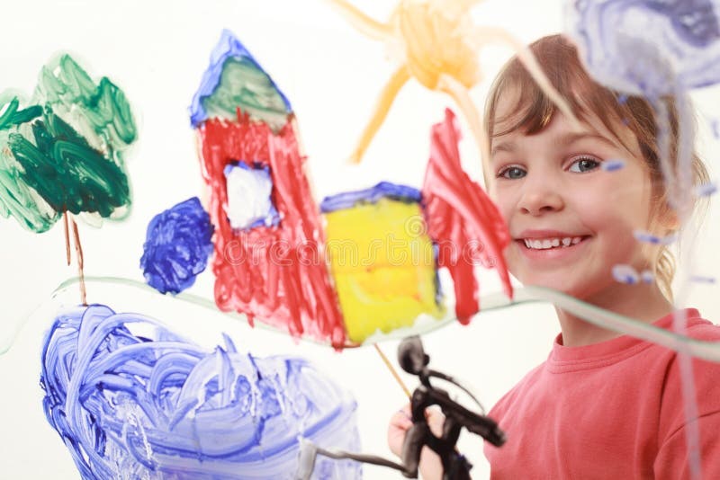 Little girl paints on glass and smiles royalty free stock image Little girl paints on glass and smiles royalty free stock image
