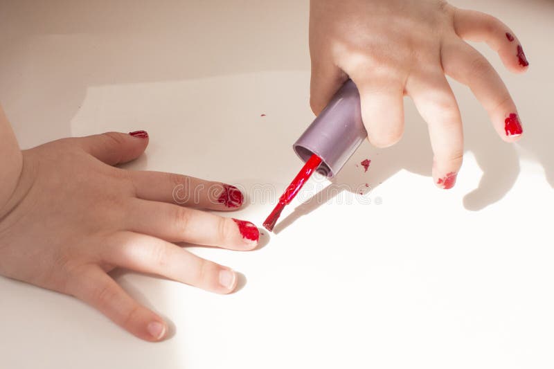 A Little Girl Paints Her Nails with Red Varnish Stock Photo Image of