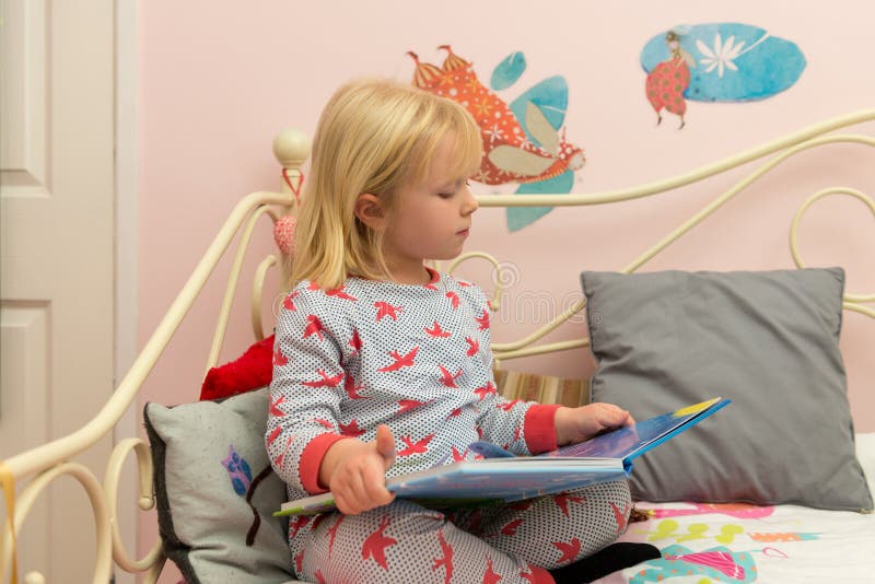 Little Girl in Pajamas Reading a Book in Bed Stock Photo Image of pyjamas, bedtime 86290712