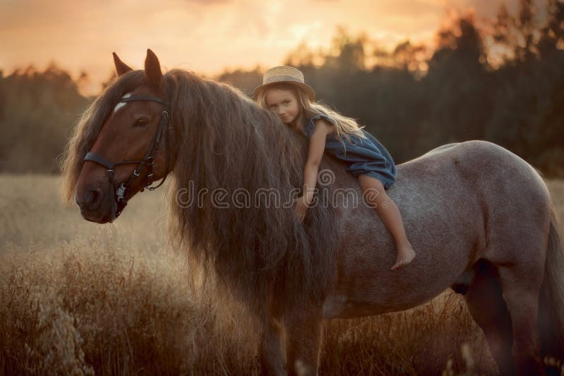Little girl with palomino miniature horse in summer day. Long haired Little girl  in casual style with palomino miniature horse stallion in summer day