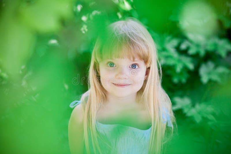 Little girl in park wearing blue dress