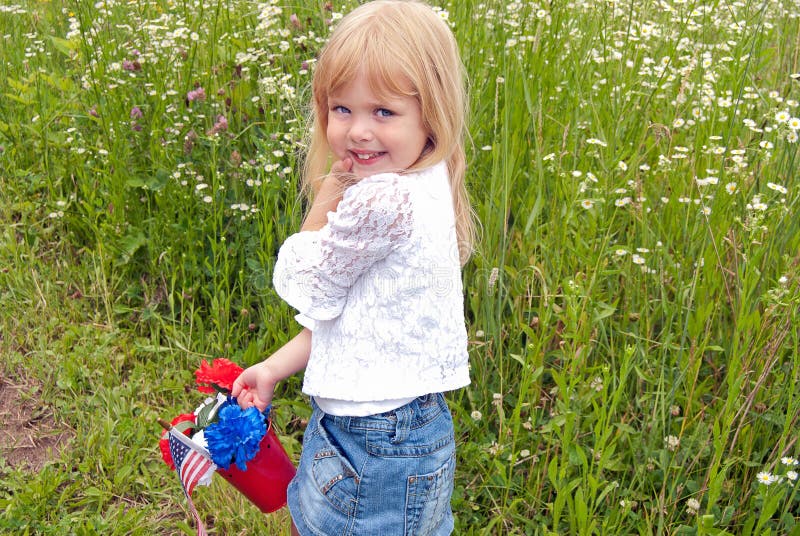 Little girl with patriotic bouquet in red pail