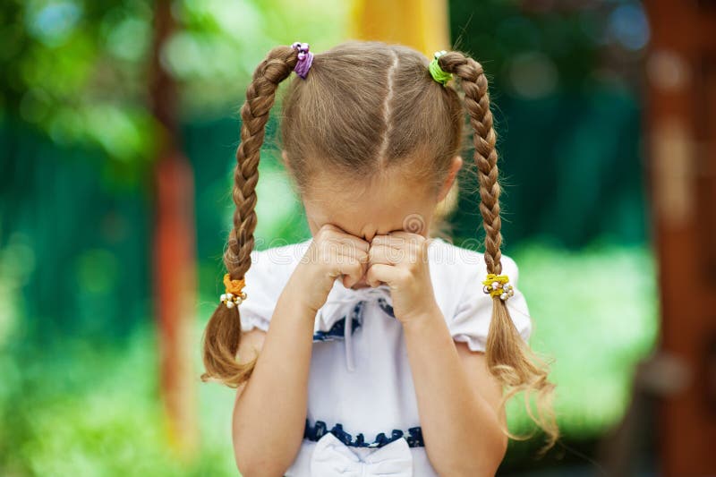 Little girl with pigtails crying stock photo