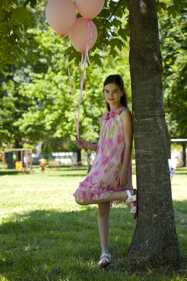 Little girl with pink balllons