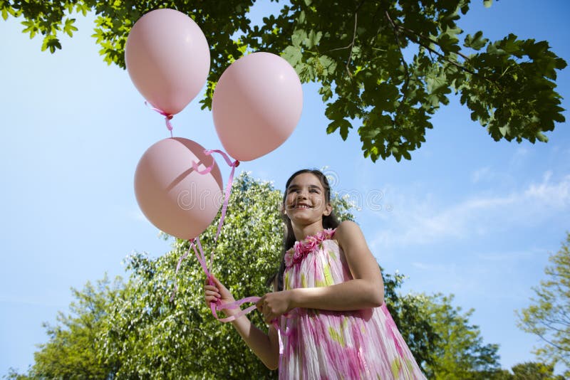 Little girl with pink balllons