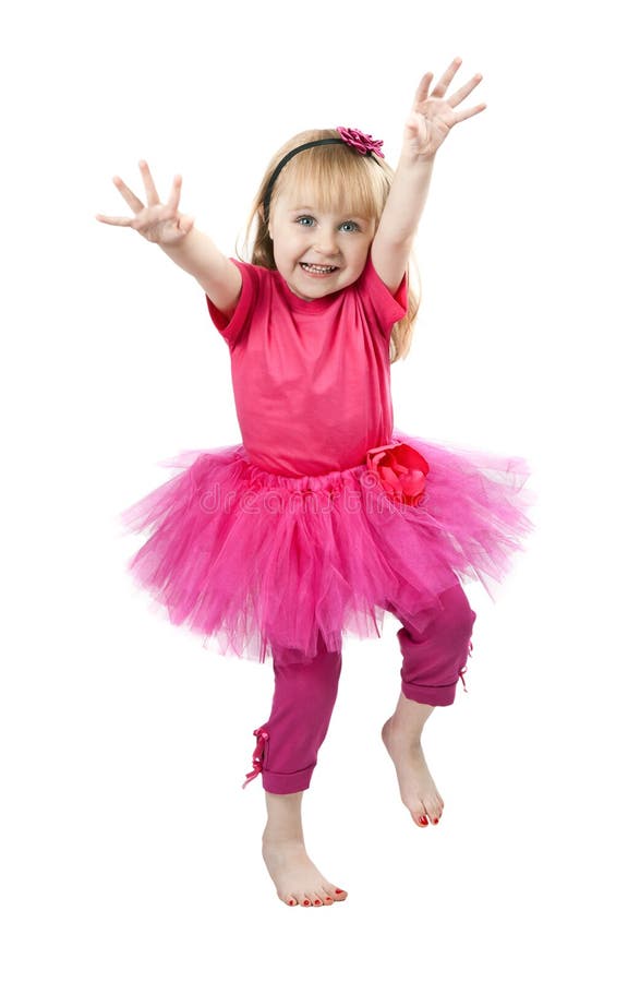 Little girl in a pink dress dancing in studio