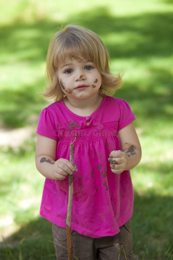 Little girl in pink with muddy face